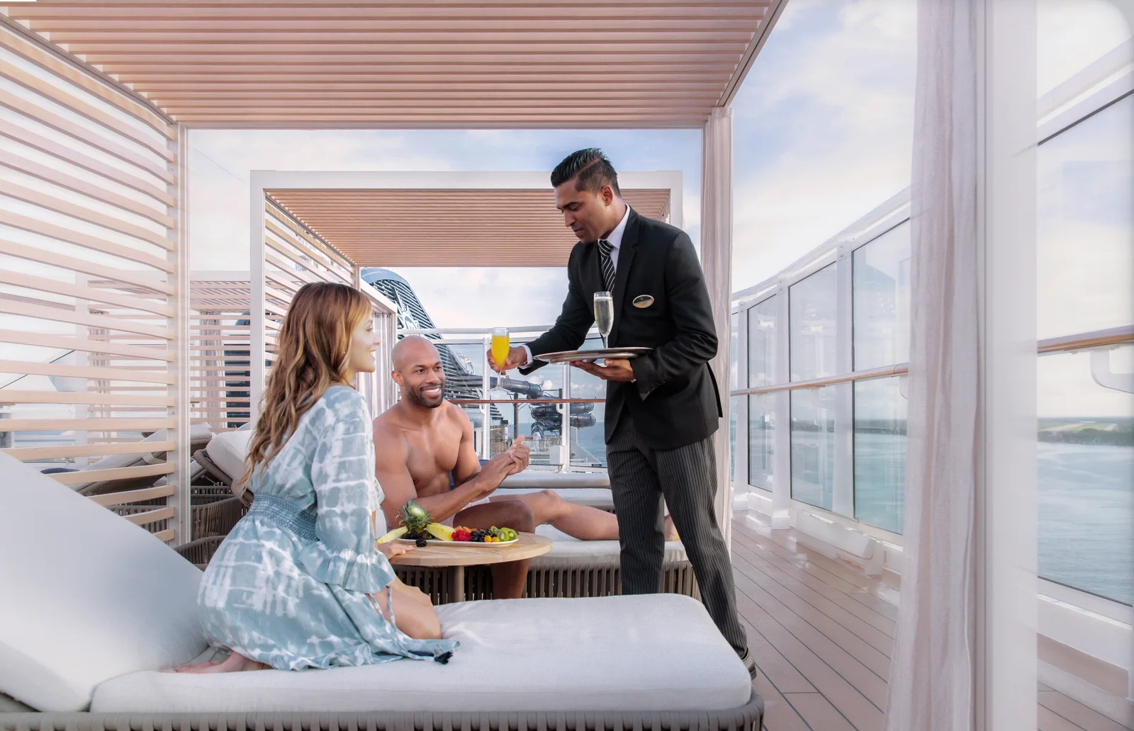 Butler serving guests on MSC Yacht Club deck